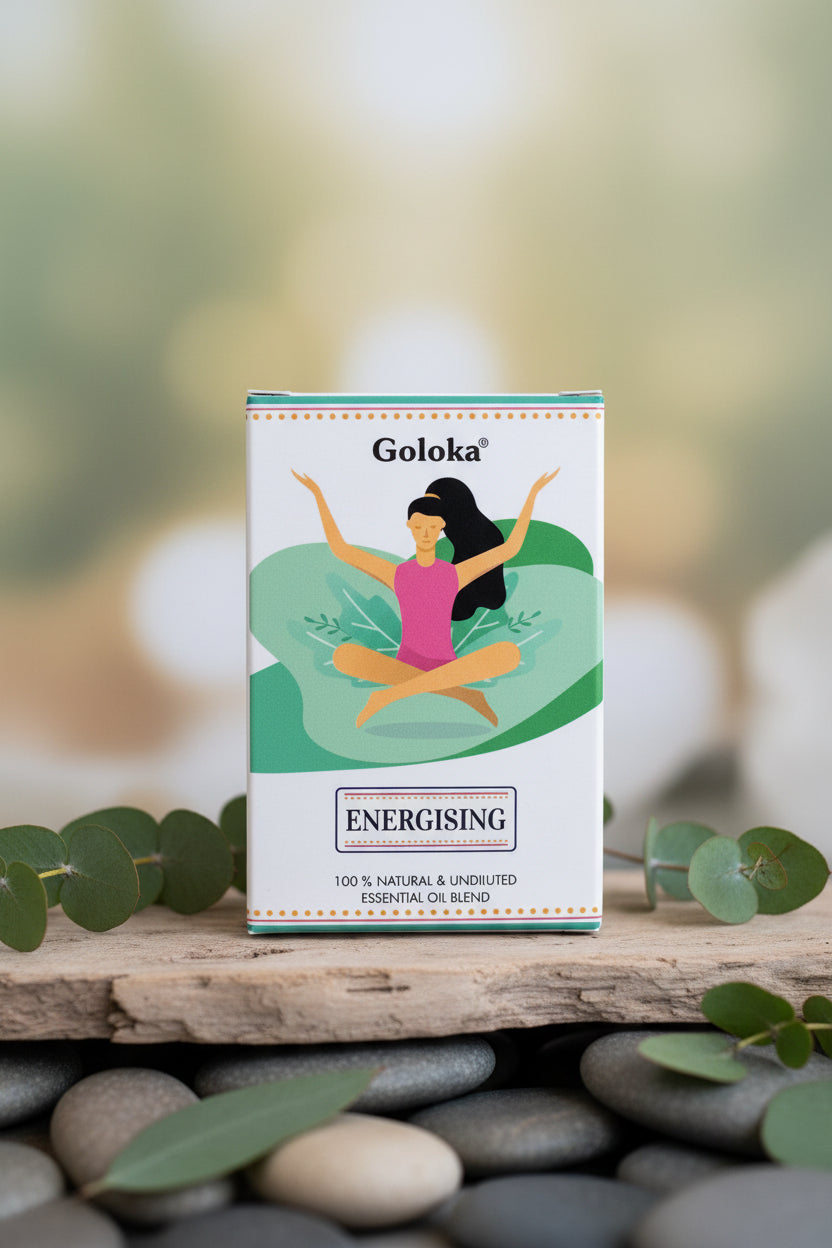 Goloka Energising essential oil blend packaging on a light wooden surface with crystals in the background.